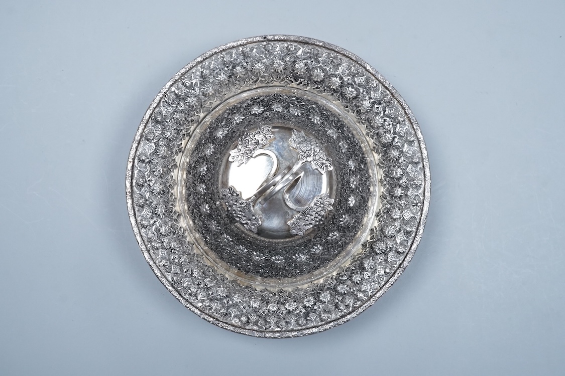 A 20th century Middle Eastern white metal circular dish and cover, embossed with flower heads, stamped '84', base diameter 24.2cm, 28.2oz.